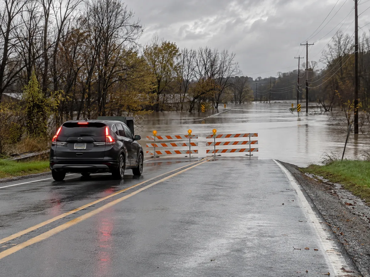 A barricaded flooded roadway that drivers must avoid